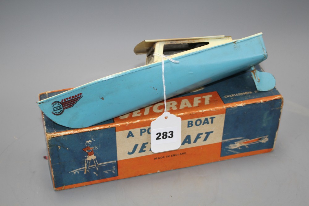 A boxed Jetex plastic fuel propelled model boat, a Jetcraft tinplate burner propelled model power boat and a boxed Mechanex pressed foi